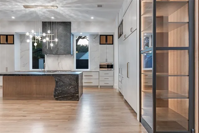 a kitchen with stainless steel appliances granite countertop a stove and a sink