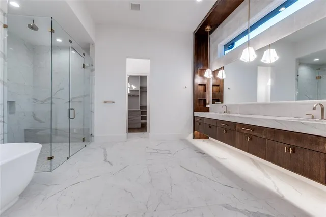 an empty room with wooden floor and mirror