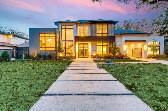 a front view of a brick house with a yard