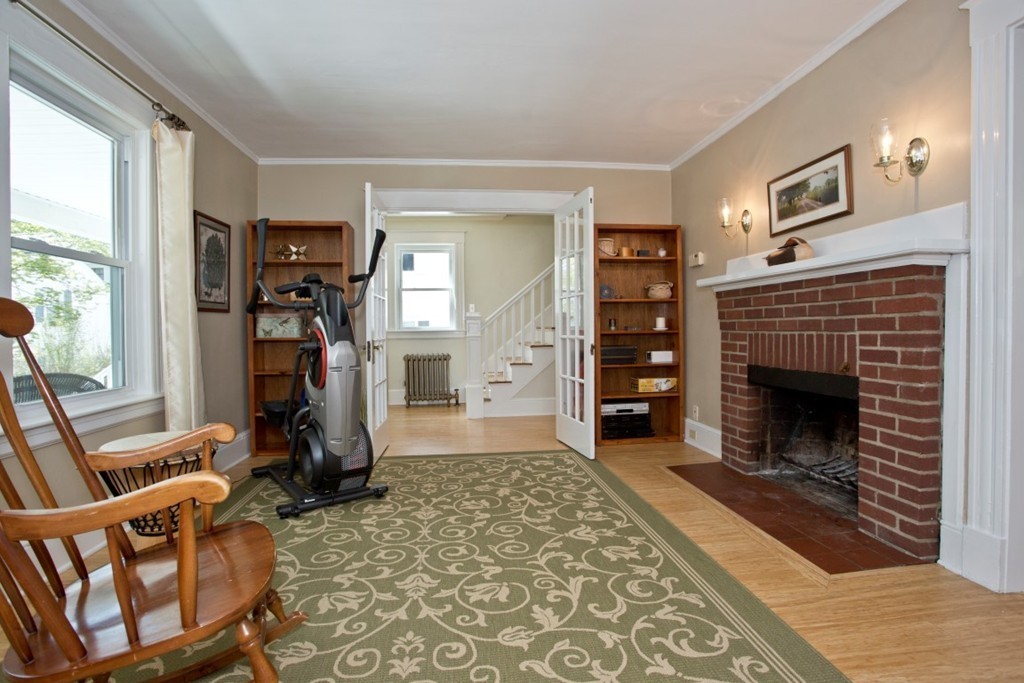 11 Brattle Place Arlington, MA 02474 - Photo 18 of 30 a living room with furniture a fireplace and a large window