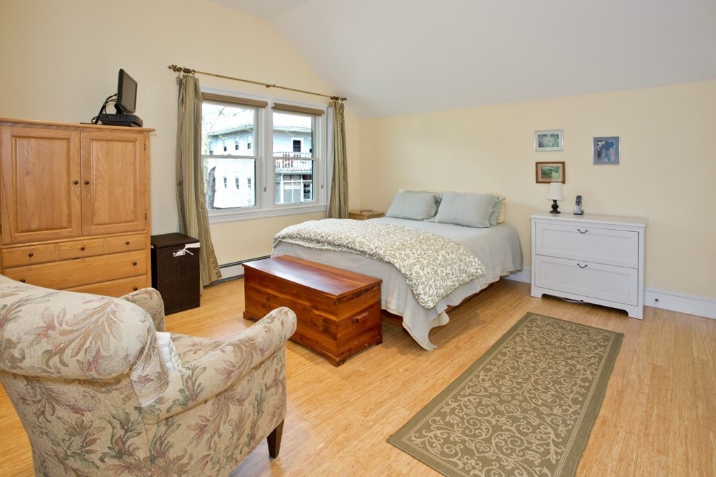 11 Brattle Place Arlington, MA 02474 - Photo 21 of 30 a bedroom with a bed and wooden floor