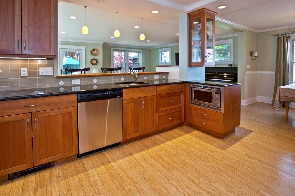 11 Brattle Place Arlington, MA 02474 - Photo 4 of 30 a kitchen with stainless steel appliances granite countertop a stove a sink and a microwave