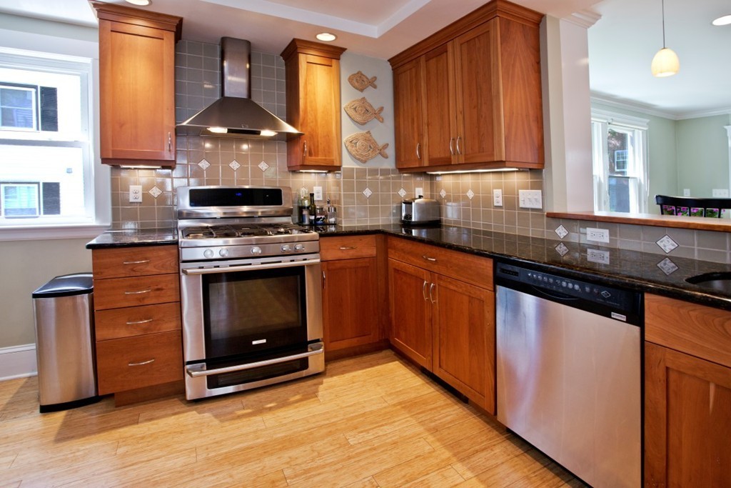 11 Brattle Place Arlington, MA 02474 - Photo 5 of 30 a kitchen with stainless steel appliances granite countertop a stove a sink and a microwave