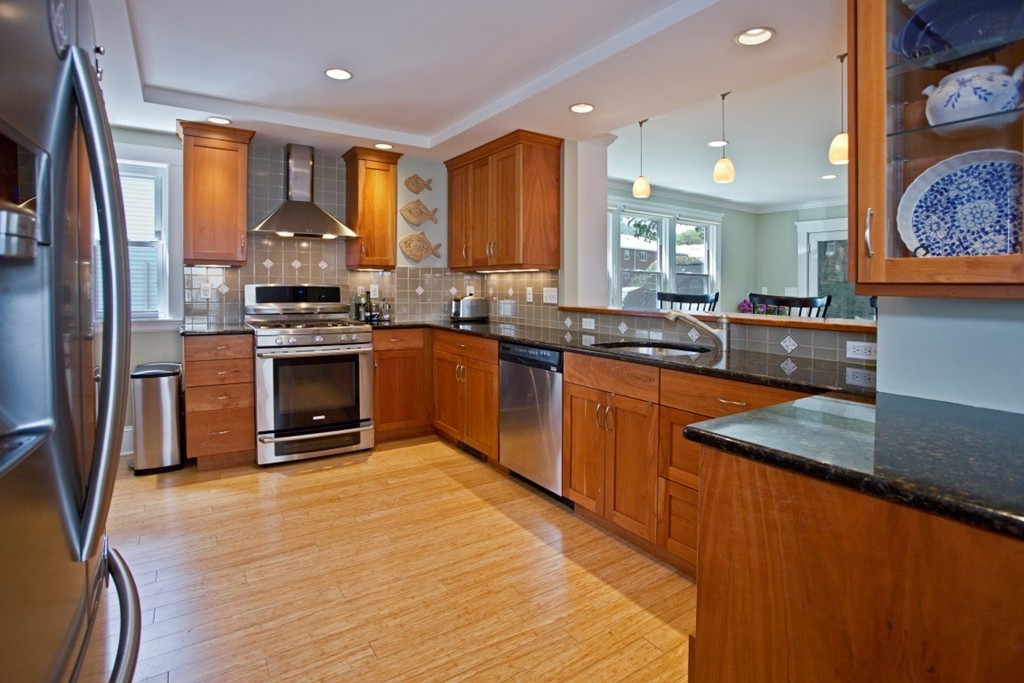 11 Brattle Place Arlington, MA 02474 - Photo 6 of 30 a kitchen with stainless steel appliances granite countertop a sink a stove and a refrigerator