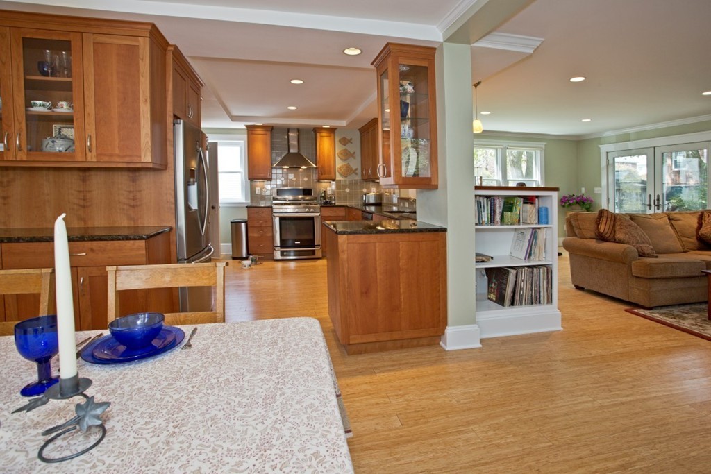 11 Brattle Place Arlington, MA 02474 - Photo 7 of 30 a living room with furniture kitchen view and a wooden floor