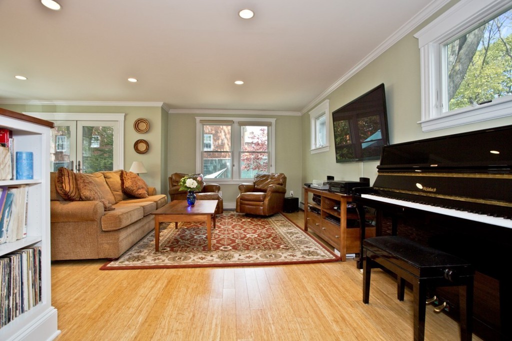11 Brattle Place Arlington, MA 02474 - Photo 9 of 30 a living room with furniture and a fireplace
