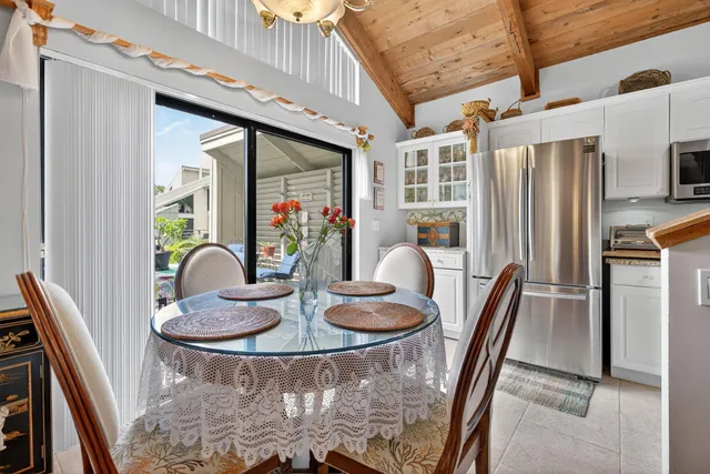 a dining room with furniture and a floor to ceiling window