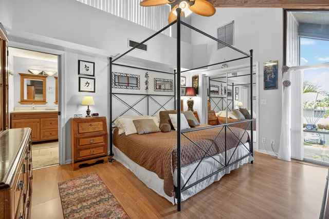 a bedroom with a bed and wooden floor