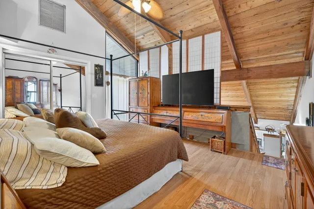 a bedroom with a bed and a flat screen tv