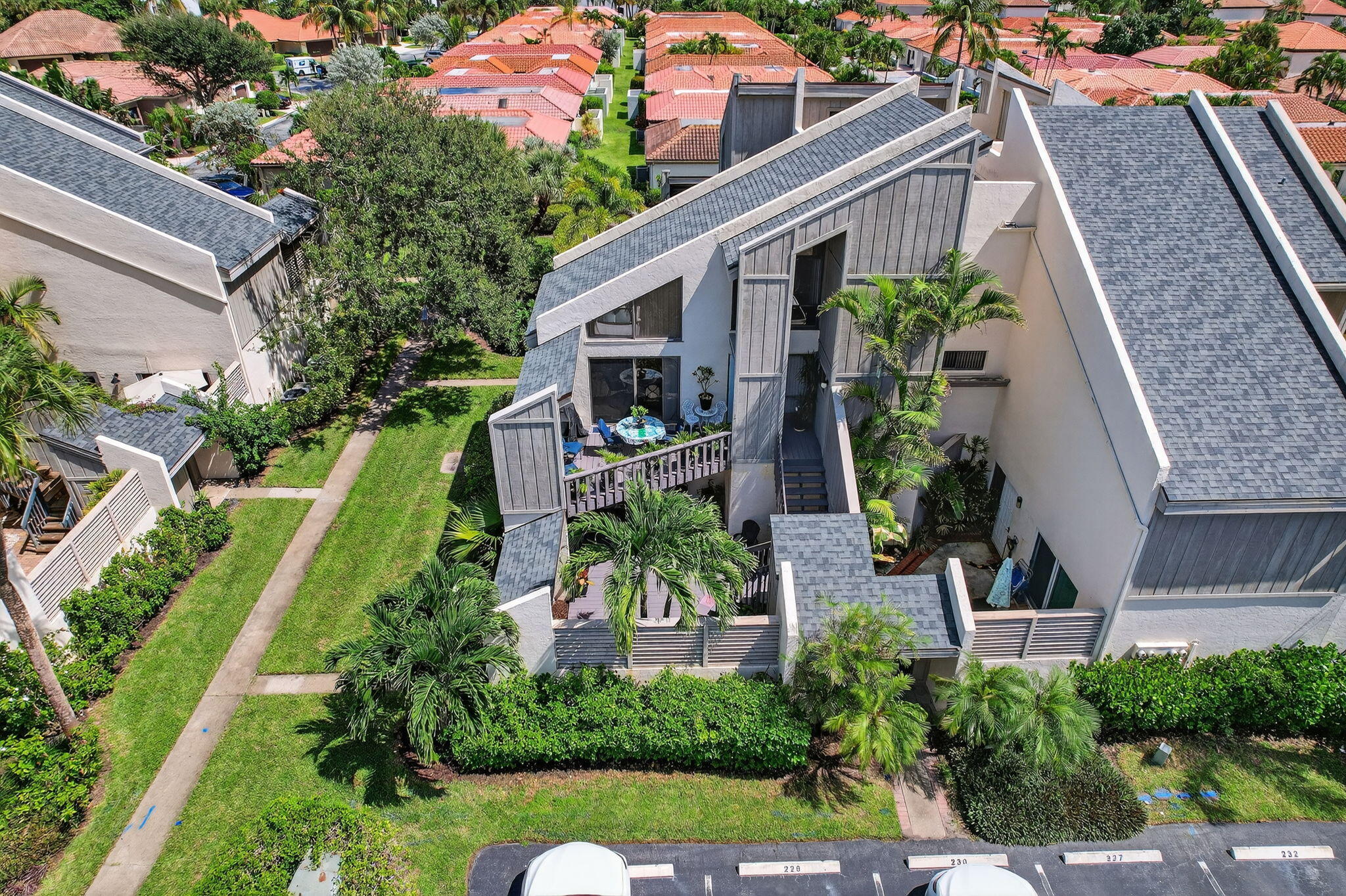 1605 Highway 1, Unit 8E Jupiter, FL 33477 - Photo 2 of 47 a front view of a house with a yard