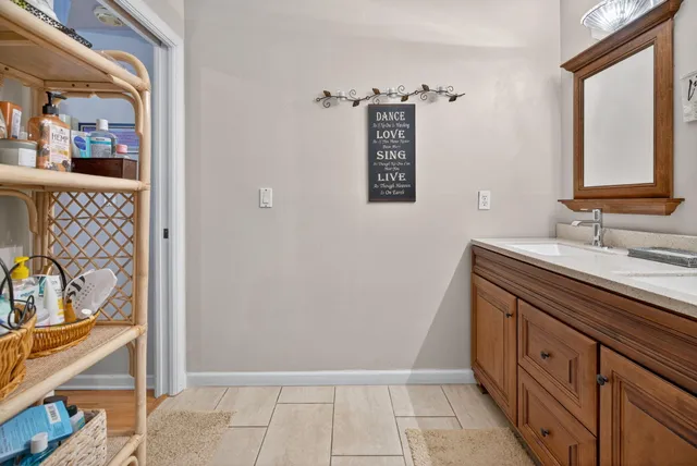 a bathroom with a sink a mirror and a shower