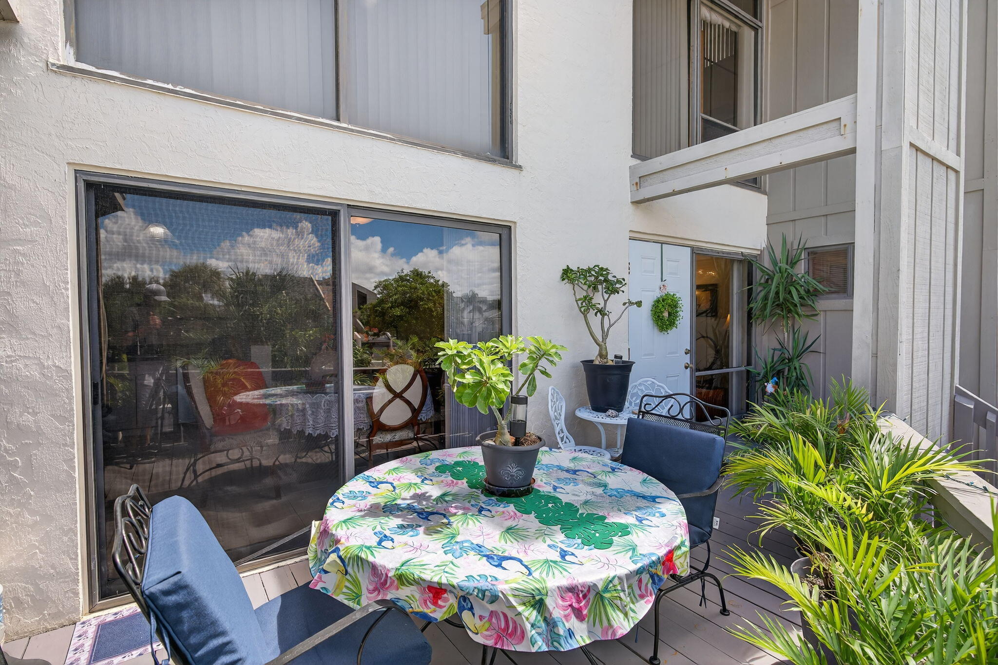 1605 Highway 1, Unit 8E Jupiter, FL 33477 - Photo 25 of 47 a dining room with furniture a potted plant and a floor to ceiling window