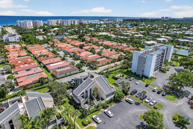 an aerial view of residential houses with outdoor space and swimming pool