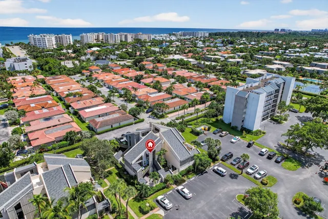 an aerial view of residential houses with outdoor space and street view
