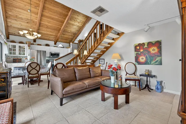 a living room with furniture a rug and white walls