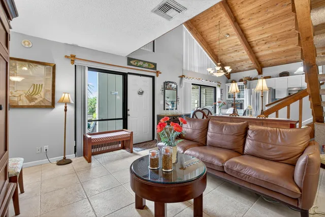 a living room with furniture a rug and a large window