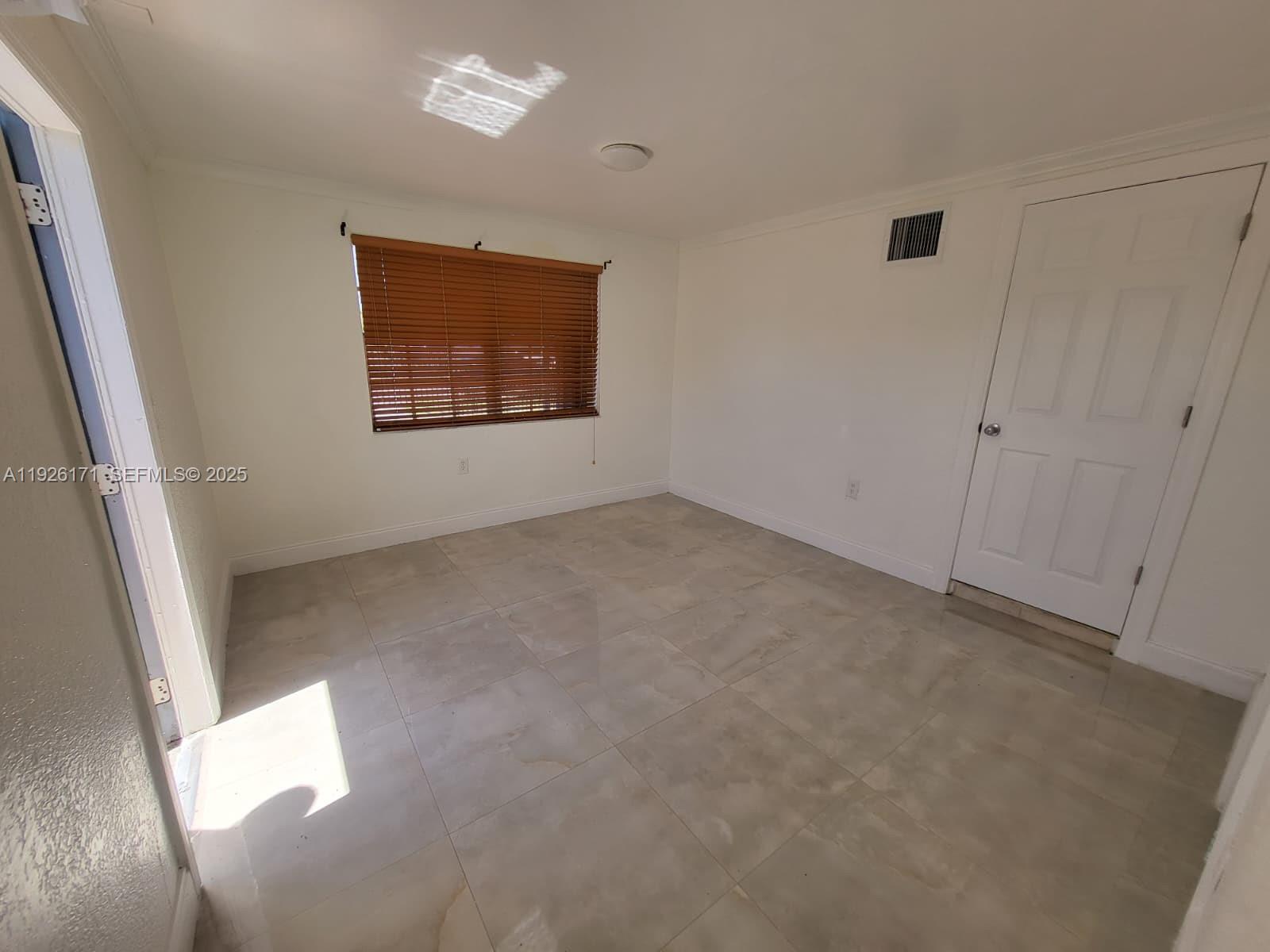 15320 Southwest 298th Terrace, Unit 15320 Homestead, FL 33033 - Photo 11 of 27 an empty room with windows