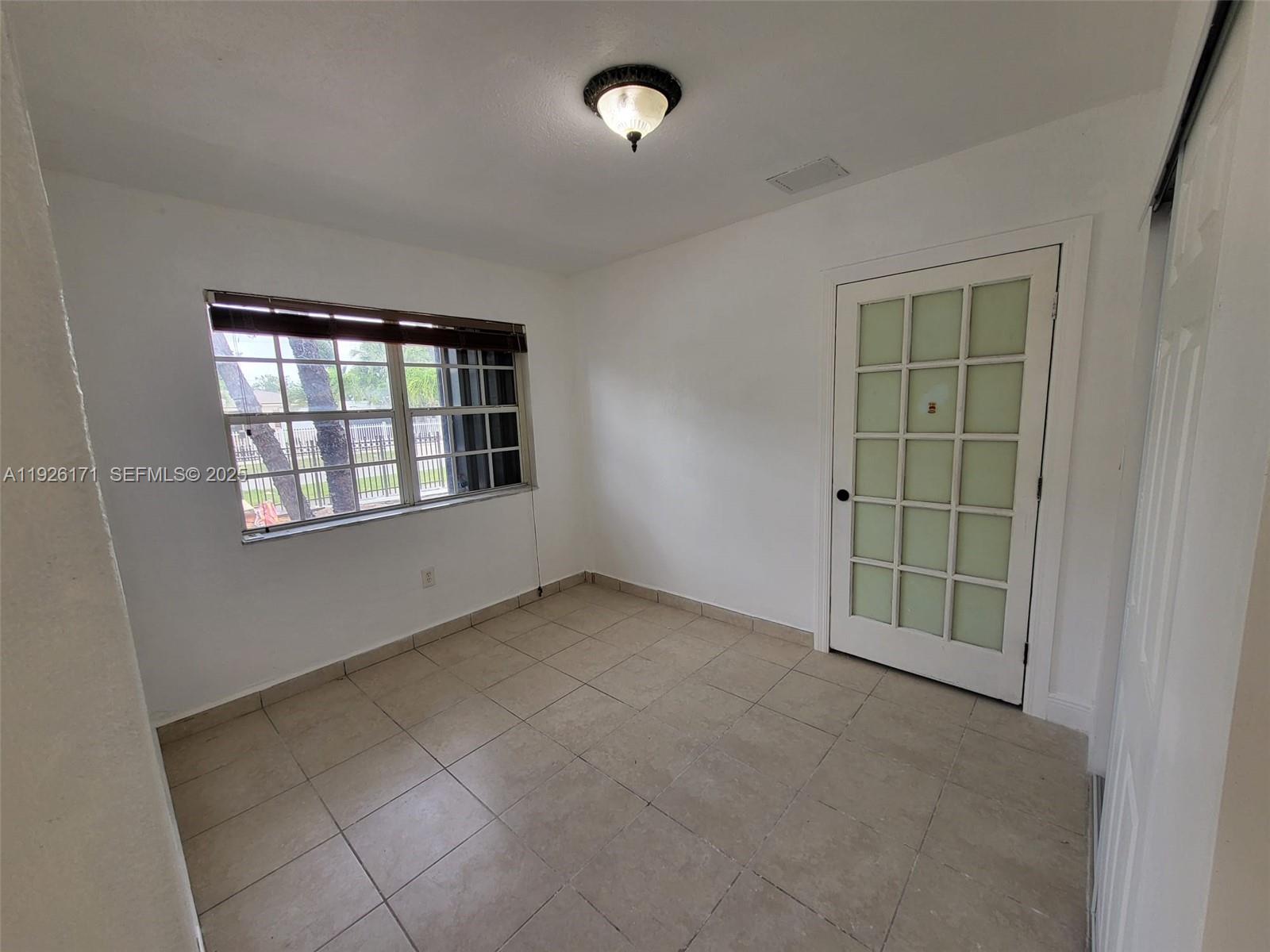 15320 Southwest 298th Terrace, Unit 15320 Homestead, FL 33033 - Photo 13 of 27 an empty room with windows