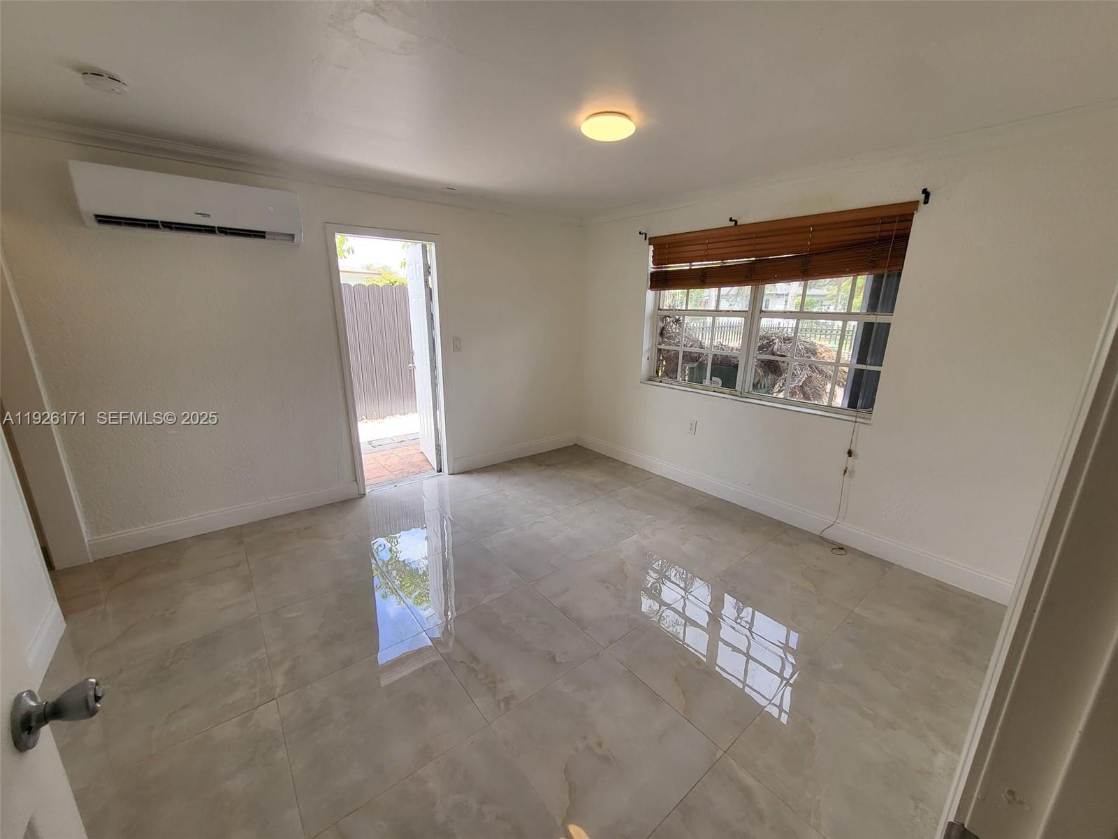 15320 Southwest 298th Terrace, Unit 15320 Homestead, FL 33033 - Photo 17 of 27 an empty room with windows