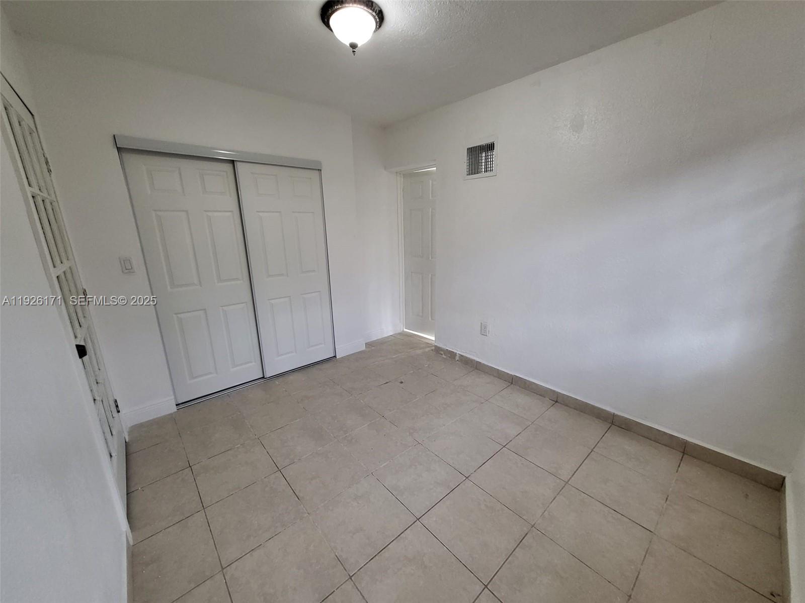 15320 Southwest 298th Terrace, Unit 15320 Homestead, FL 33033 - Photo 19 of 27 a view of an empty room and entryway