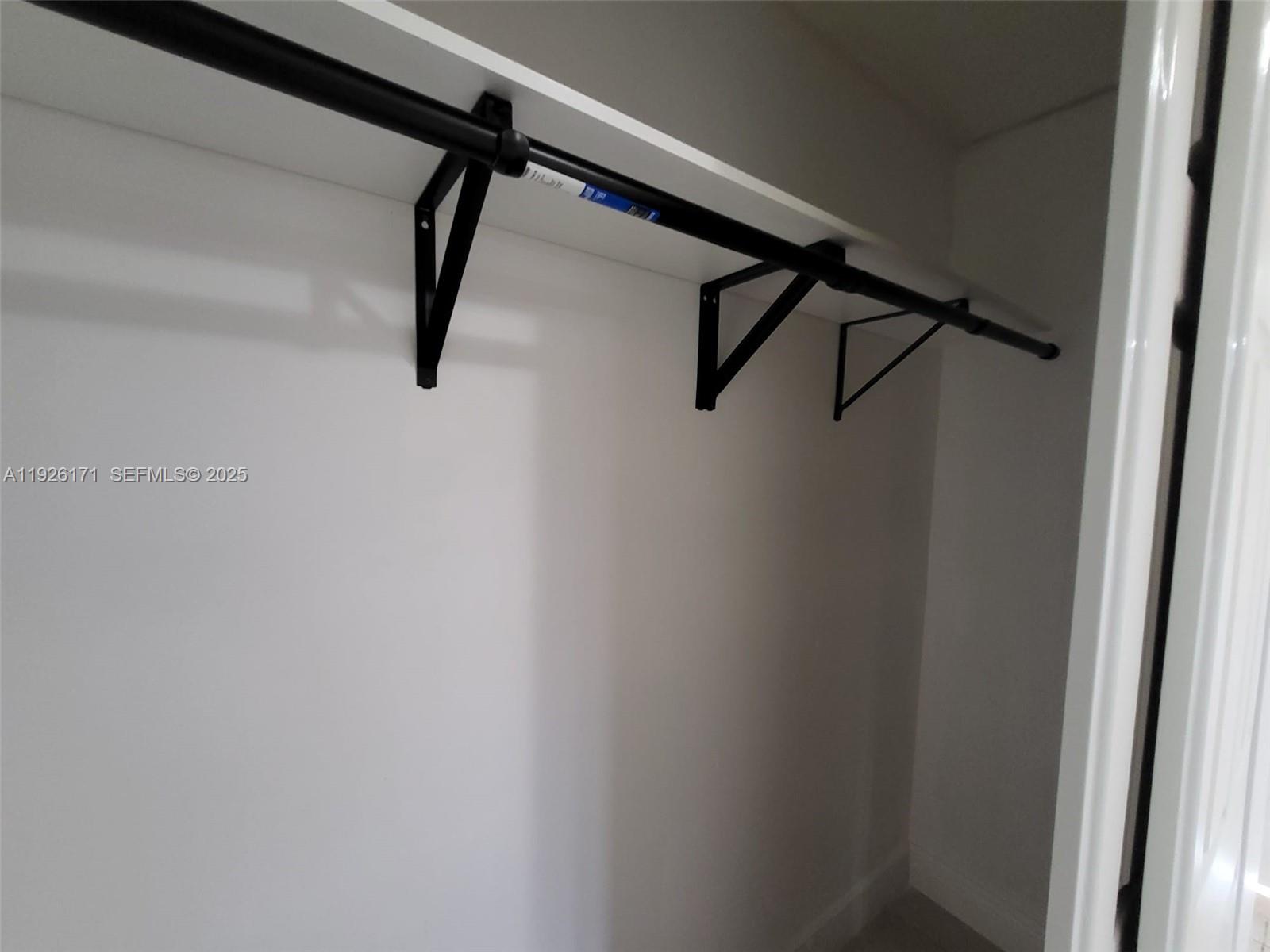 15320 Southwest 298th Terrace, Unit 15320 Homestead, FL 33033 - Photo 20 of 27 a view of a walk in closet