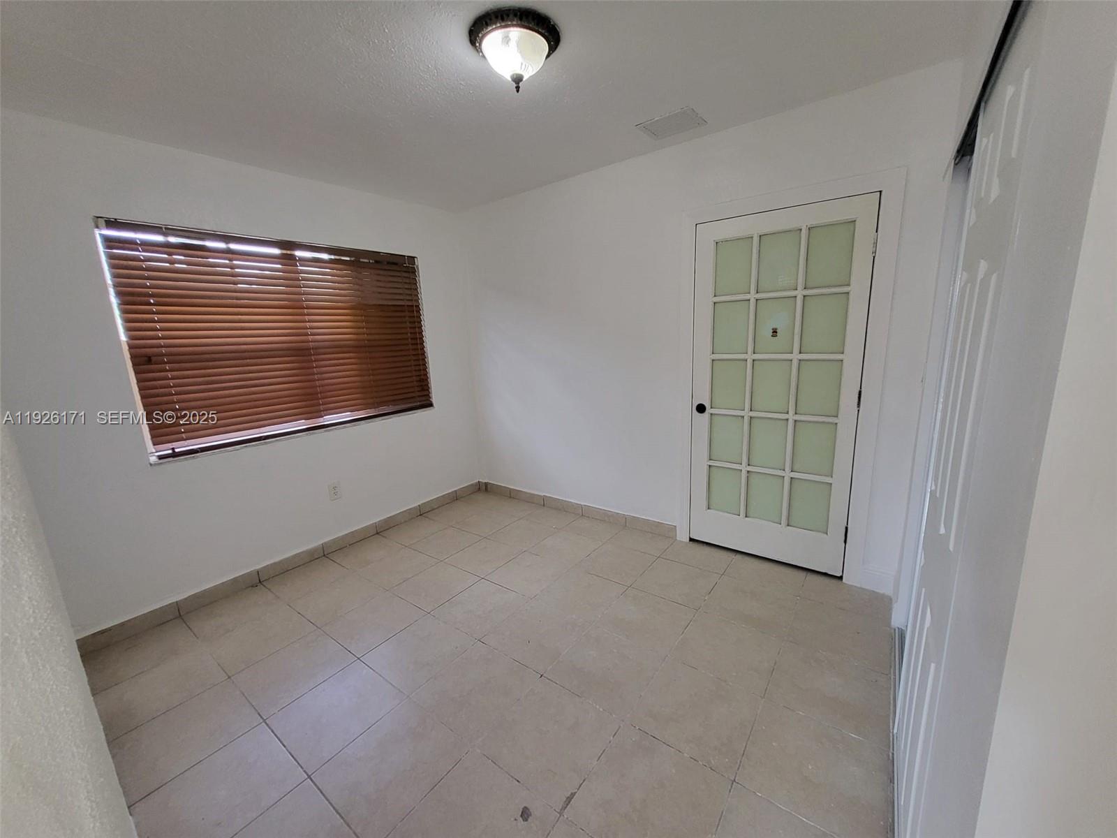 15320 Southwest 298th Terrace, Unit 15320 Homestead, FL 33033 - Photo 21 of 27 an empty room with windows