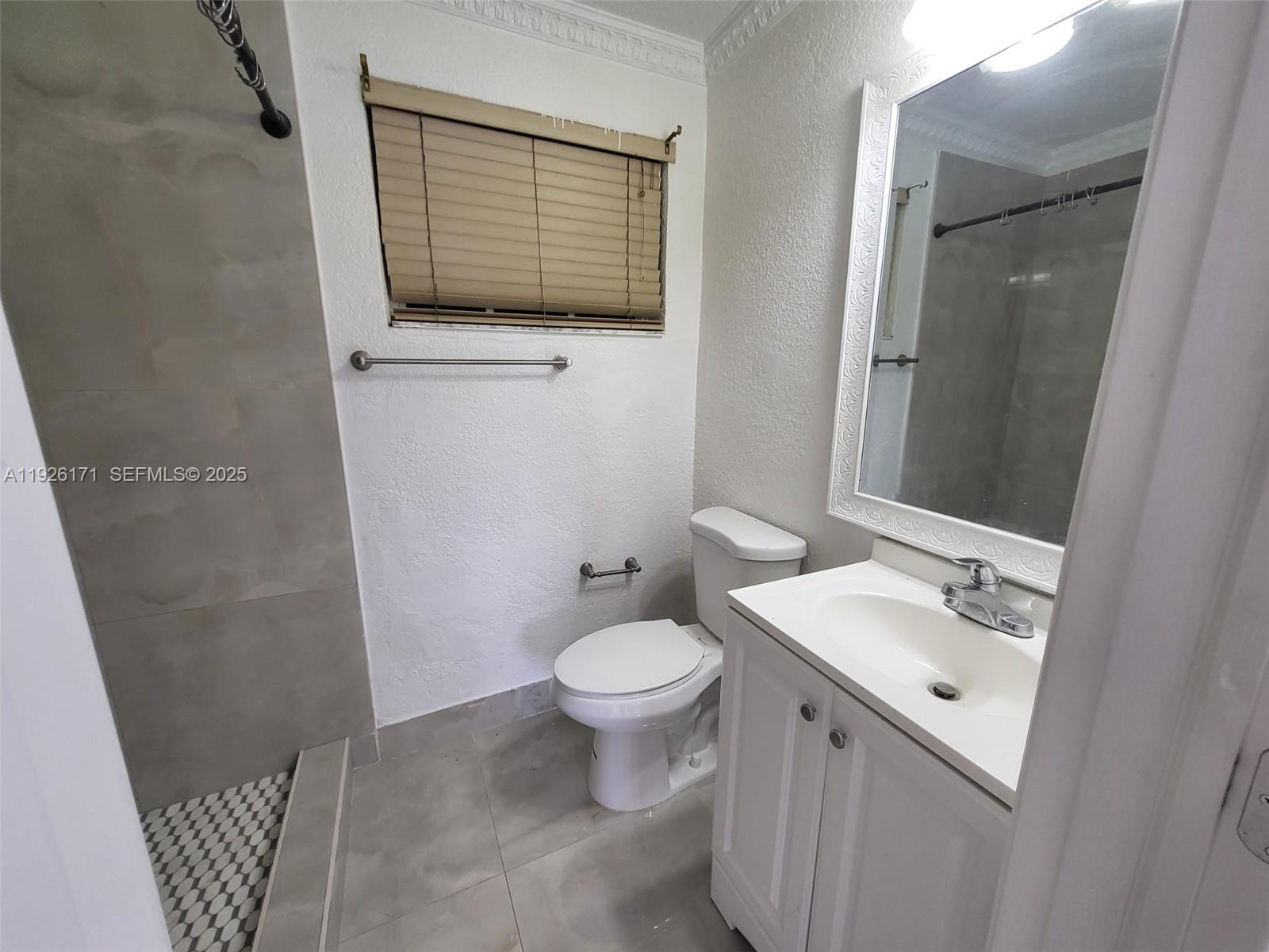 15320 Southwest 298th Terrace, Unit 15320 Homestead, FL 33033 - Photo 22 of 27 a bathroom with a sink a toilet and shower