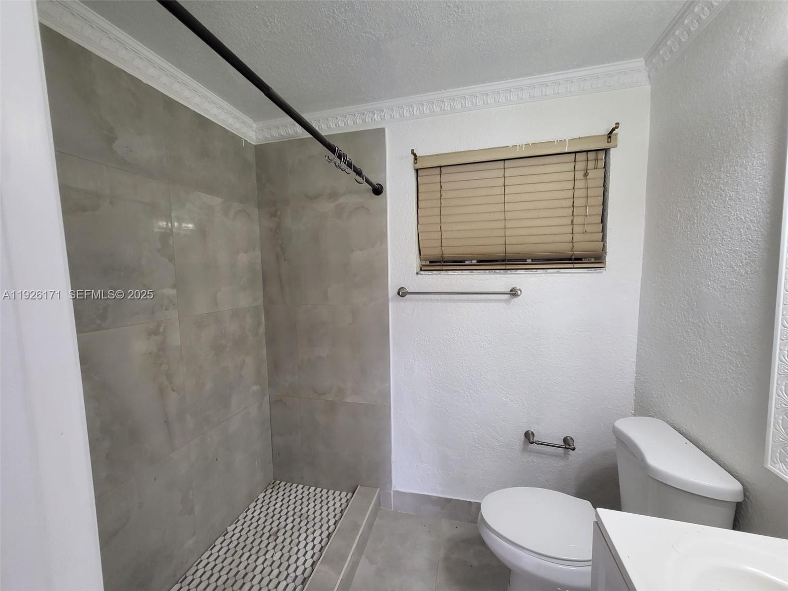 15320 Southwest 298th Terrace, Unit 15320 Homestead, FL 33033 - Photo 23 of 27 a bathroom with a toilet and a shower