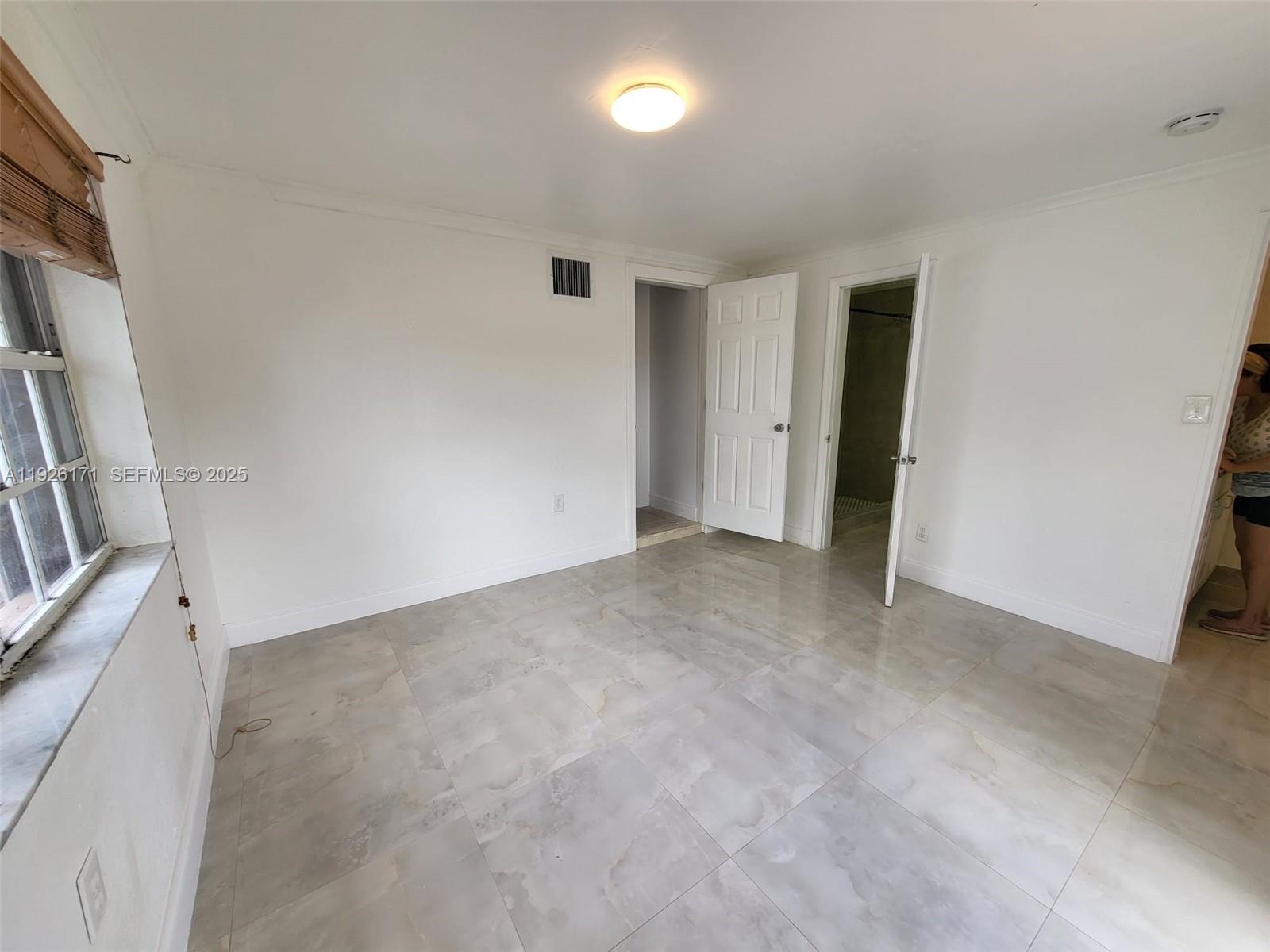 15320 Southwest 298th Terrace, Unit 15320 Homestead, FL 33033 - Photo 24 of 27 a view of an empty room with a window