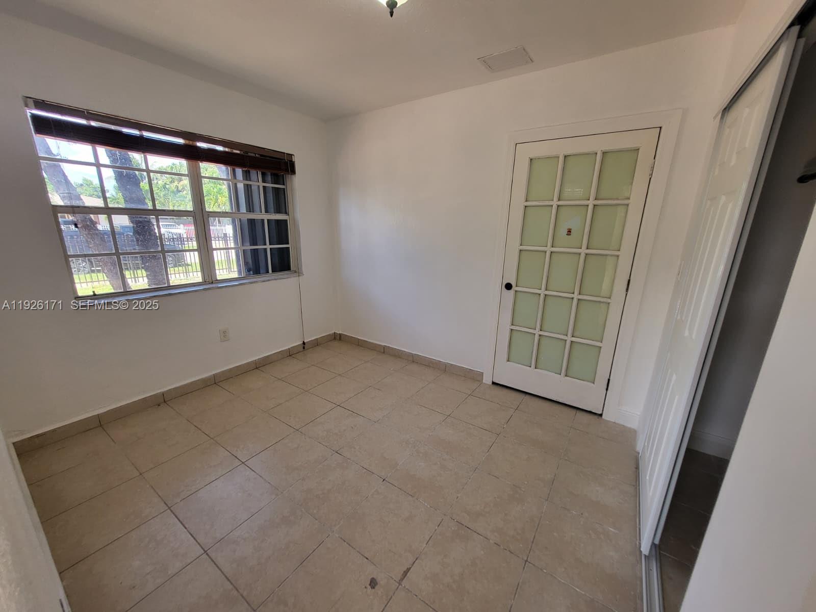 15320 Southwest 298th Terrace, Unit 15320 Homestead, FL 33033 - Photo 6 of 27 an empty room with windows