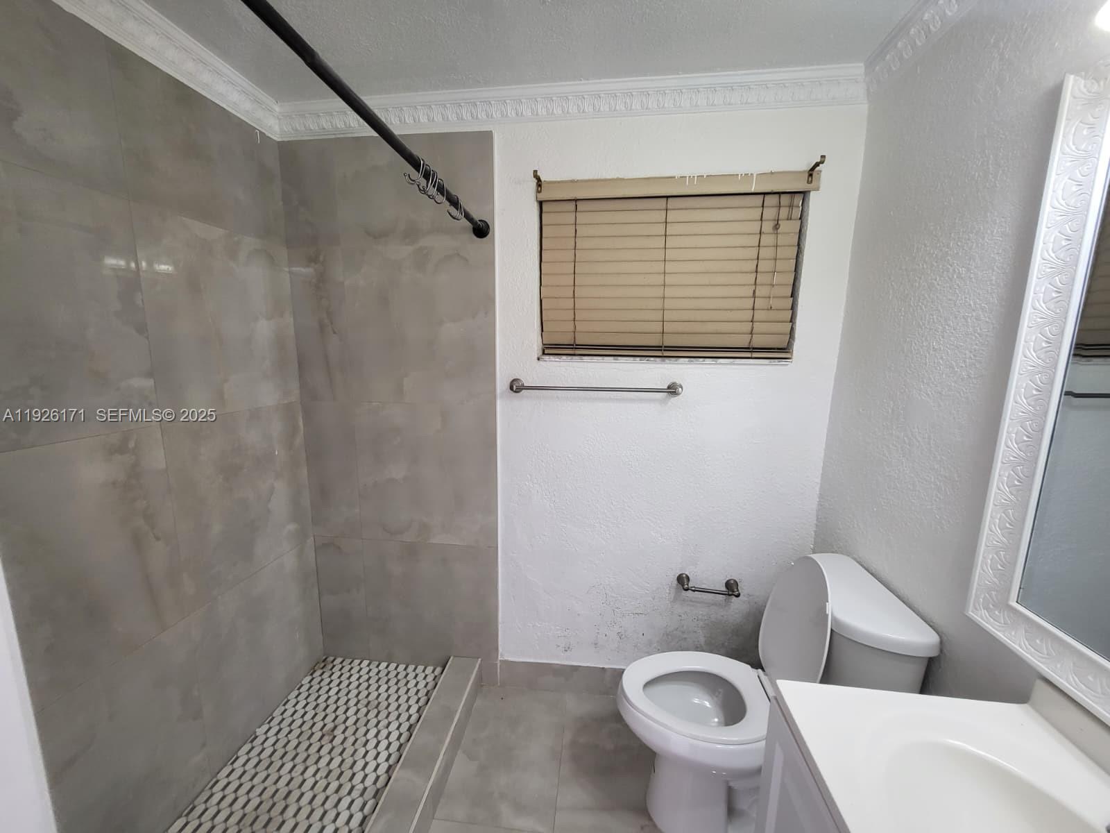 15320 Southwest 298th Terrace, Unit 15320 Homestead, FL 33033 - Photo 9 of 27 a bathroom with a toilet and a sink