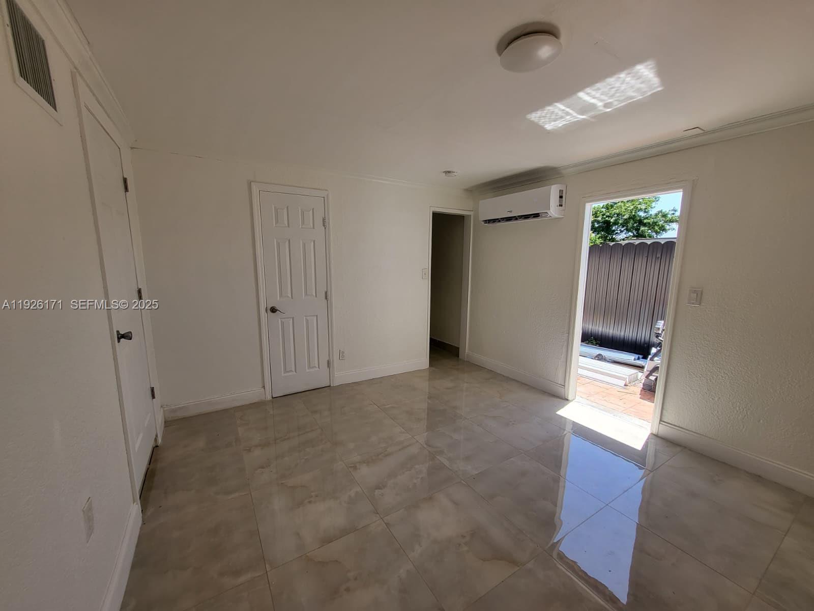 15320 Southwest 298th Terrace, Unit 15320 Homestead, FL 33033 - Photo 10 of 27 a view of an empty room with a window
