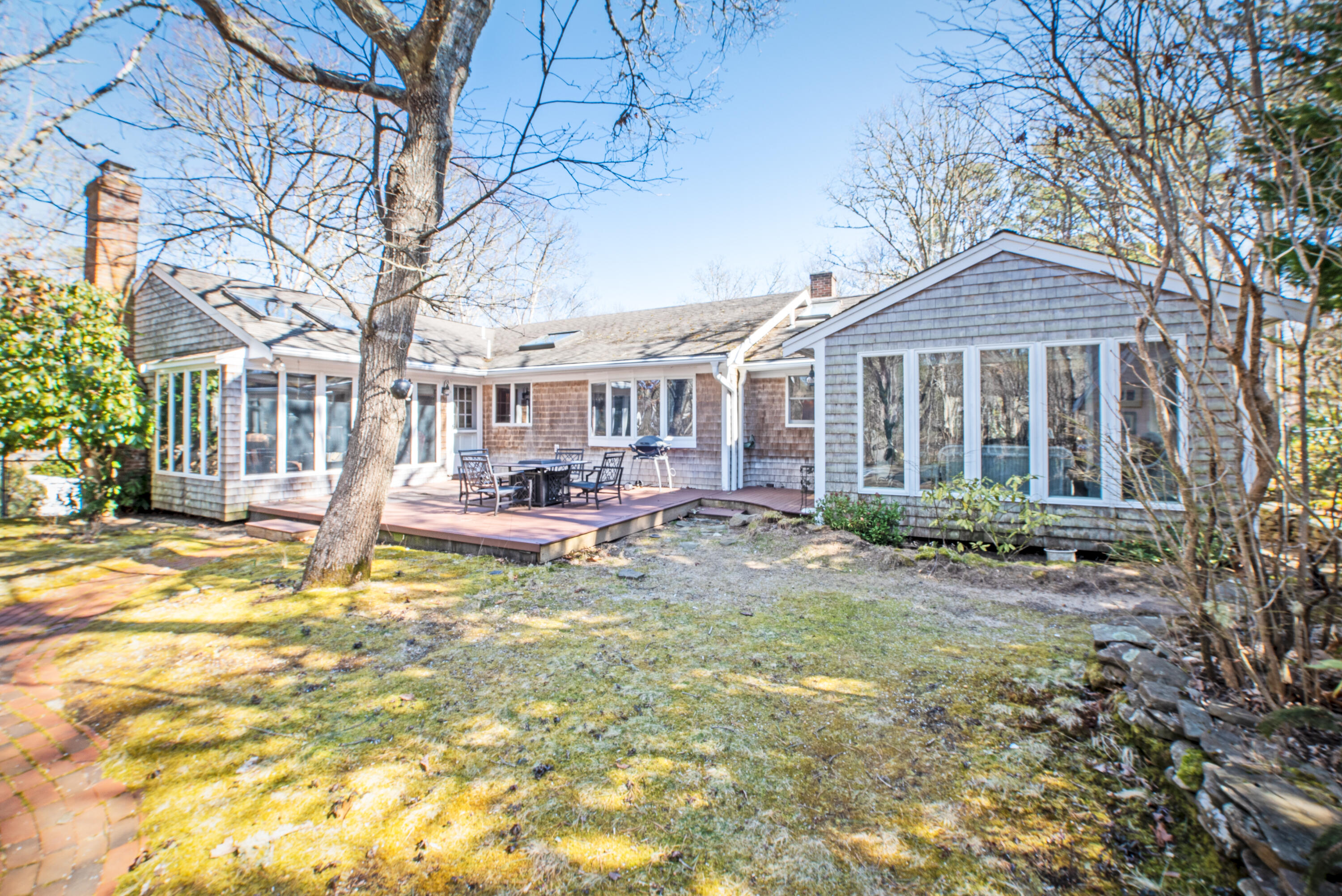 a view of a house with a yard patio and fire pit
