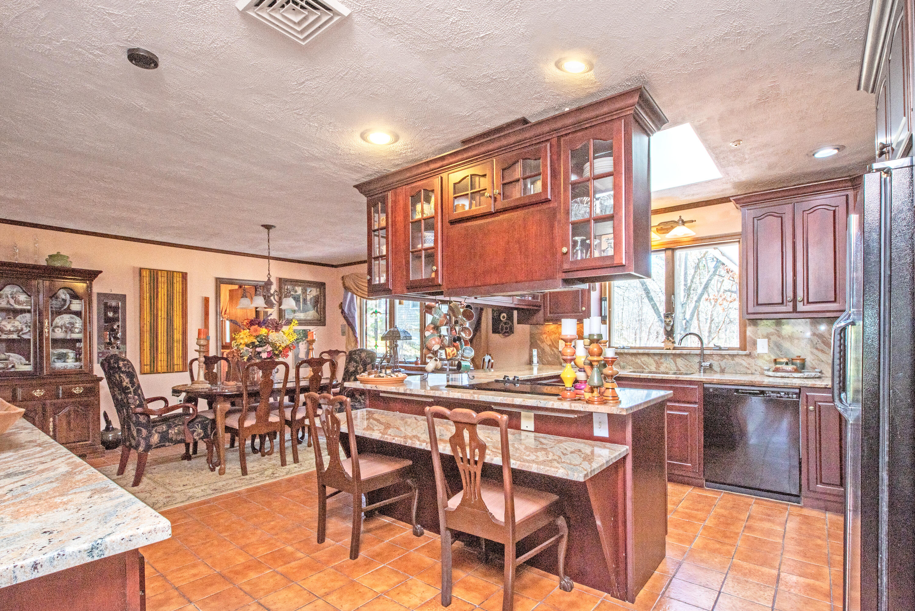 95 Herring River Road Wellfleet, MA 02667 - Photo 12 of 37 a dining hall with stainless steel appliances kitchen island granite countertop a table chairs in it and wooden floors