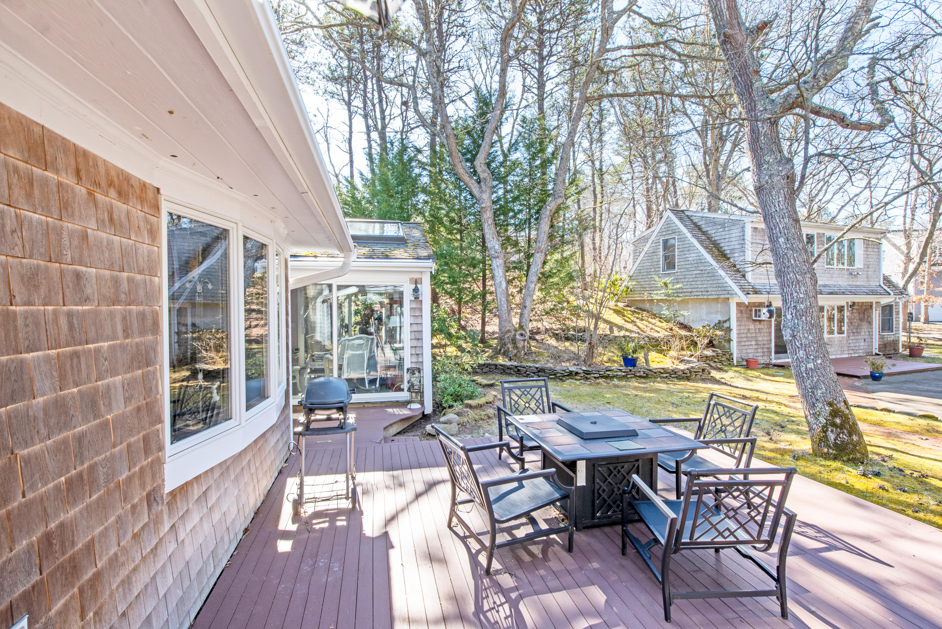 95 Herring River Road Wellfleet, MA 02667 - Photo 8 of 37 a view of a patio with couches table and chairs and wooden floor