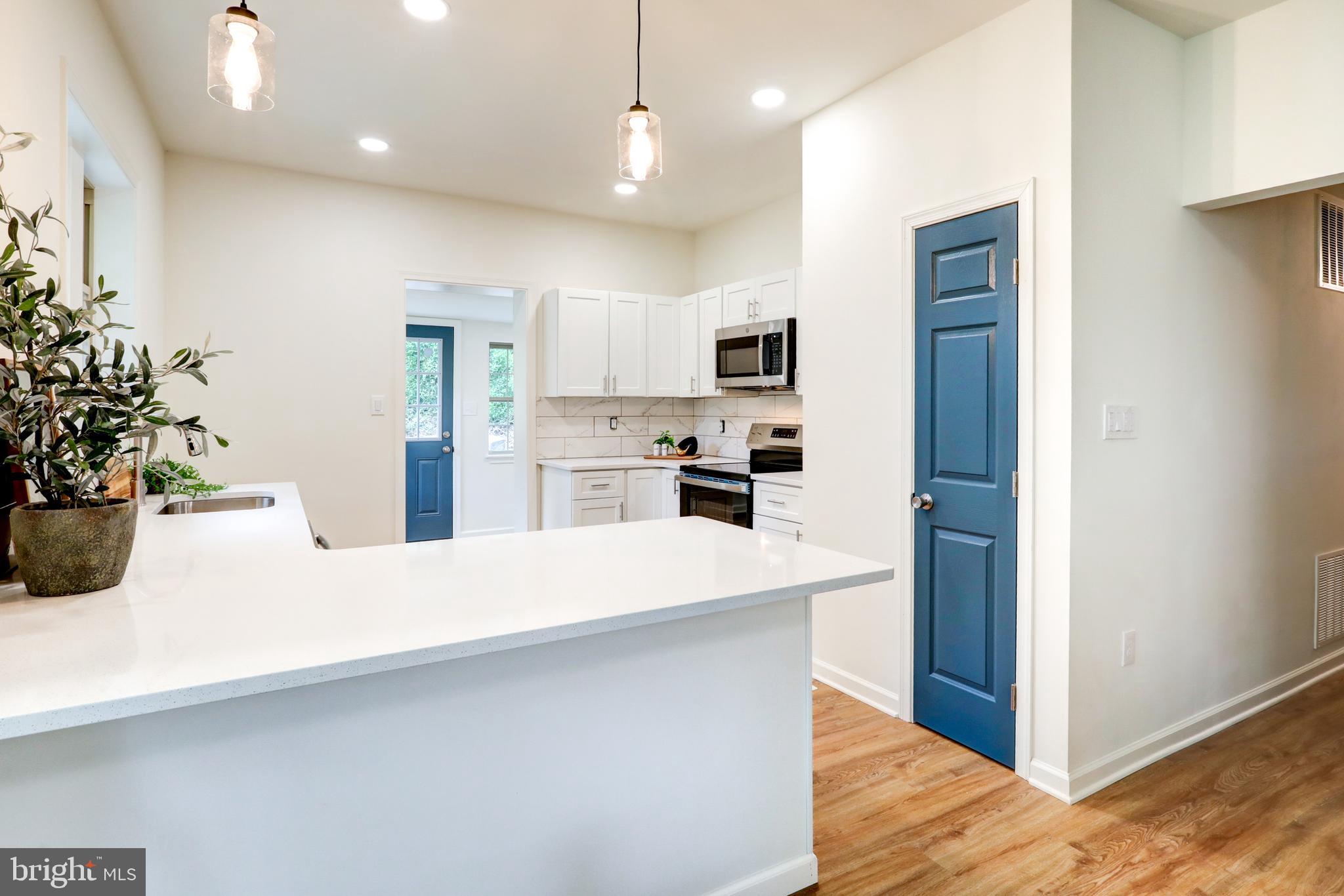 2560 Iron Springs Road Fairfield, PA 17320 - Photo 15 of 35 a kitchen with kitchen island a stove a refrigerator and a sink