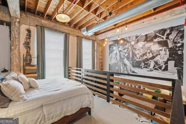 a living room with furniture a flat screen tv and floor to ceiling window