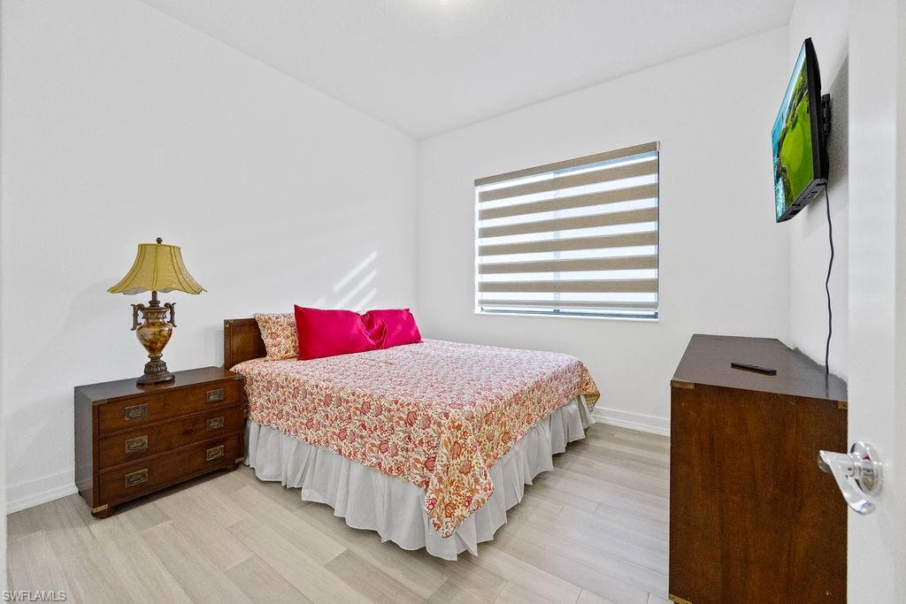 5293 Marano Drive Ave Maria, FL 34142 - Photo 11 of 23 a bedroom with a bed and a window