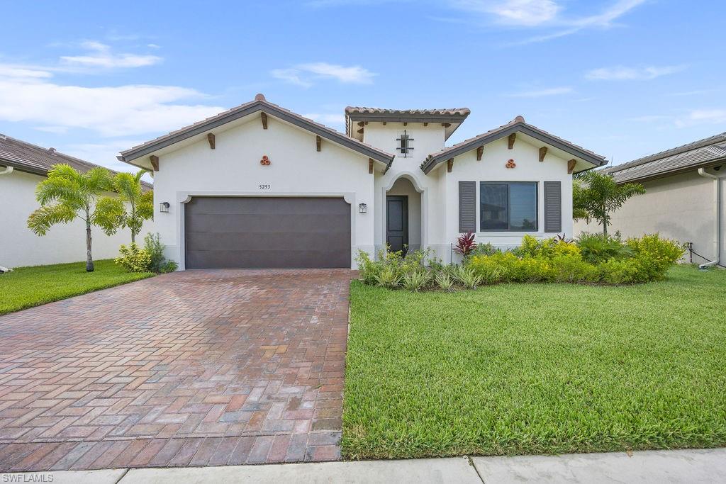 5293 Marano Drive Ave Maria, FL 34142 - Photo 2 of 23 a front view of house with yard and green space