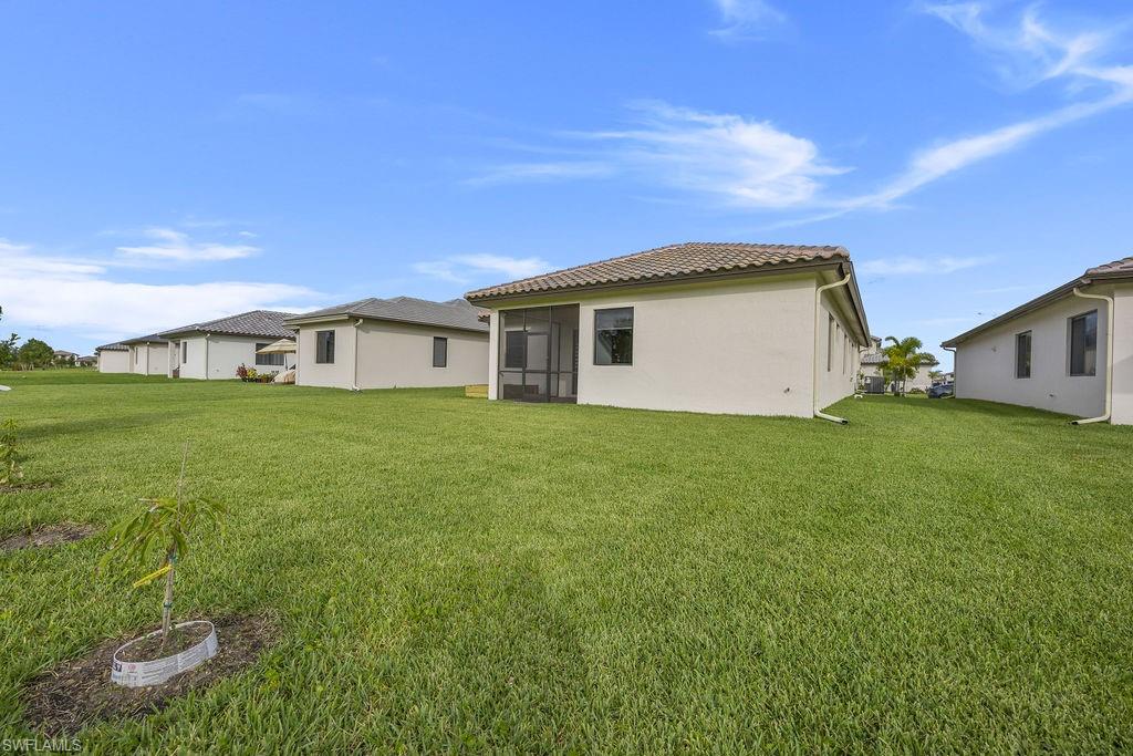 5293 Marano Drive Ave Maria, FL 34142 - Photo 22 of 23 a house view with a garden space