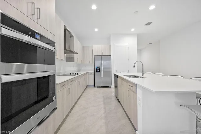 a large kitchen with a stove top oven