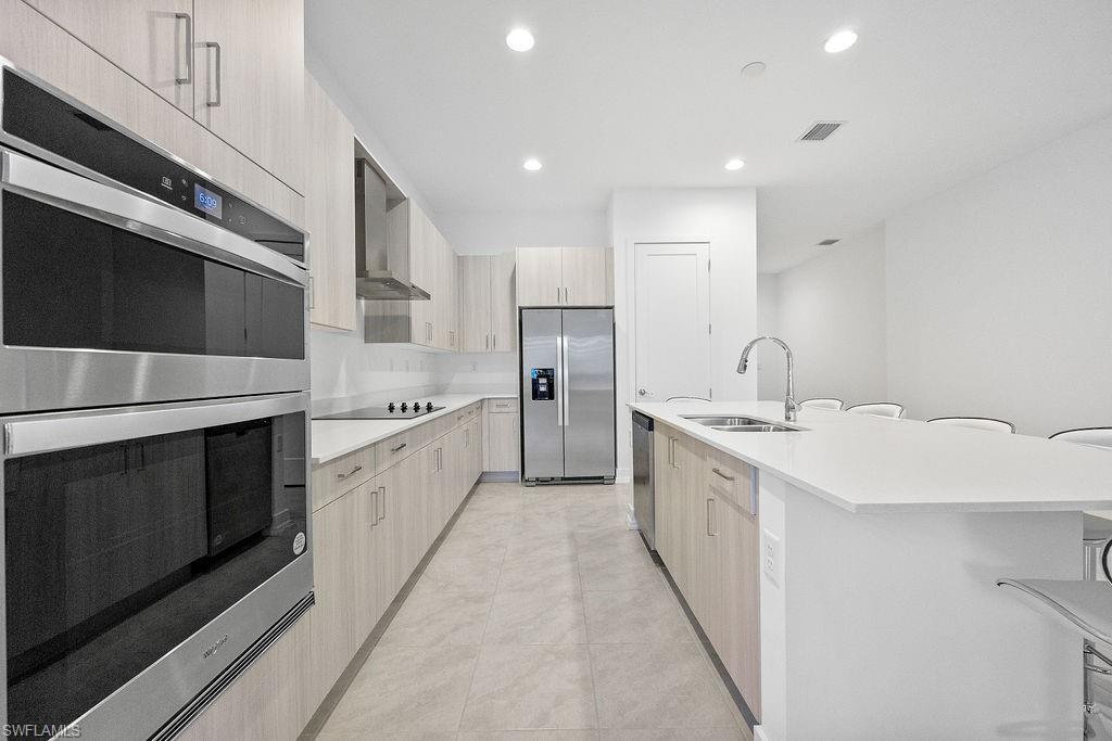 5293 Marano Drive Ave Maria, FL 34142 - Photo 6 of 23 a large kitchen with a stove top oven