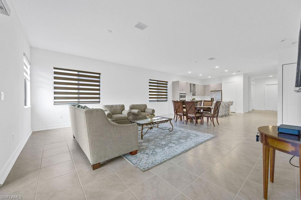 5293 Marano Drive Ave Maria, FL 34142 - Photo 10 of 23 a living room with furniture a dining table and kitchen view