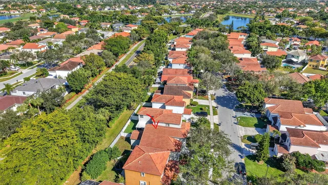 a front view of multi story residential apartment building with yard and sign board