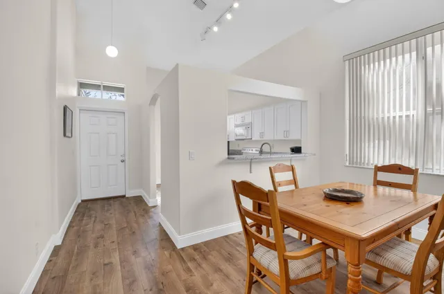 a view of a dining room with furniture and wooden floor