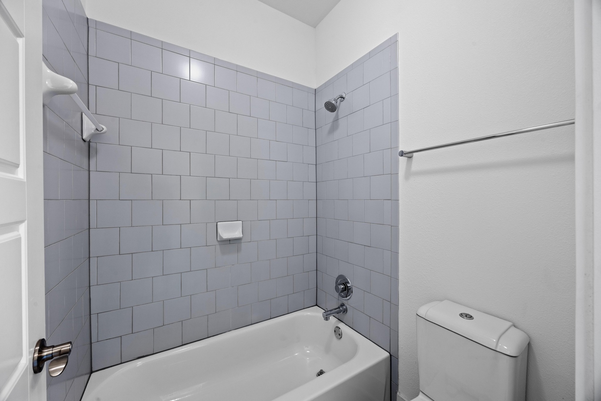 2222 Simond Avenue, Unit E Austin, TX 78723 - Photo 25 of 28 The upstairs secondary bathroom includes a shower/tub combination.