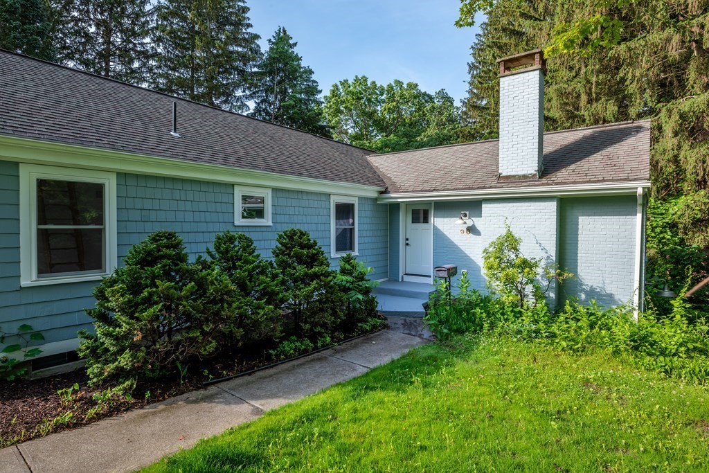 a front view of a house with garden