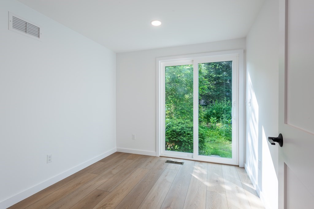 90 Memorial Drive Amherst, MA 01002 - Photo 17 of 38 an empty room with wooden floor and a window