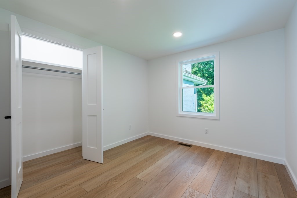 90 Memorial Drive Amherst, MA 01002 - Photo 19 of 38 an empty room with wooden floor and windows