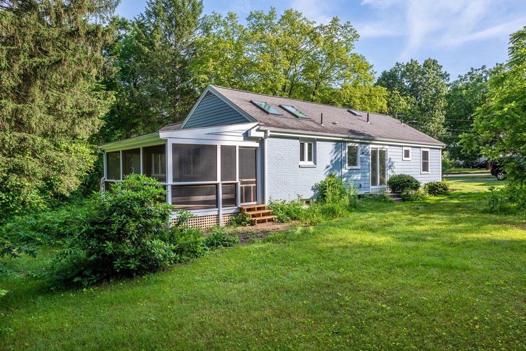 90 Memorial Drive Amherst, MA 01002 - Photo 2 of 38 a front view of a house with a yard and trees